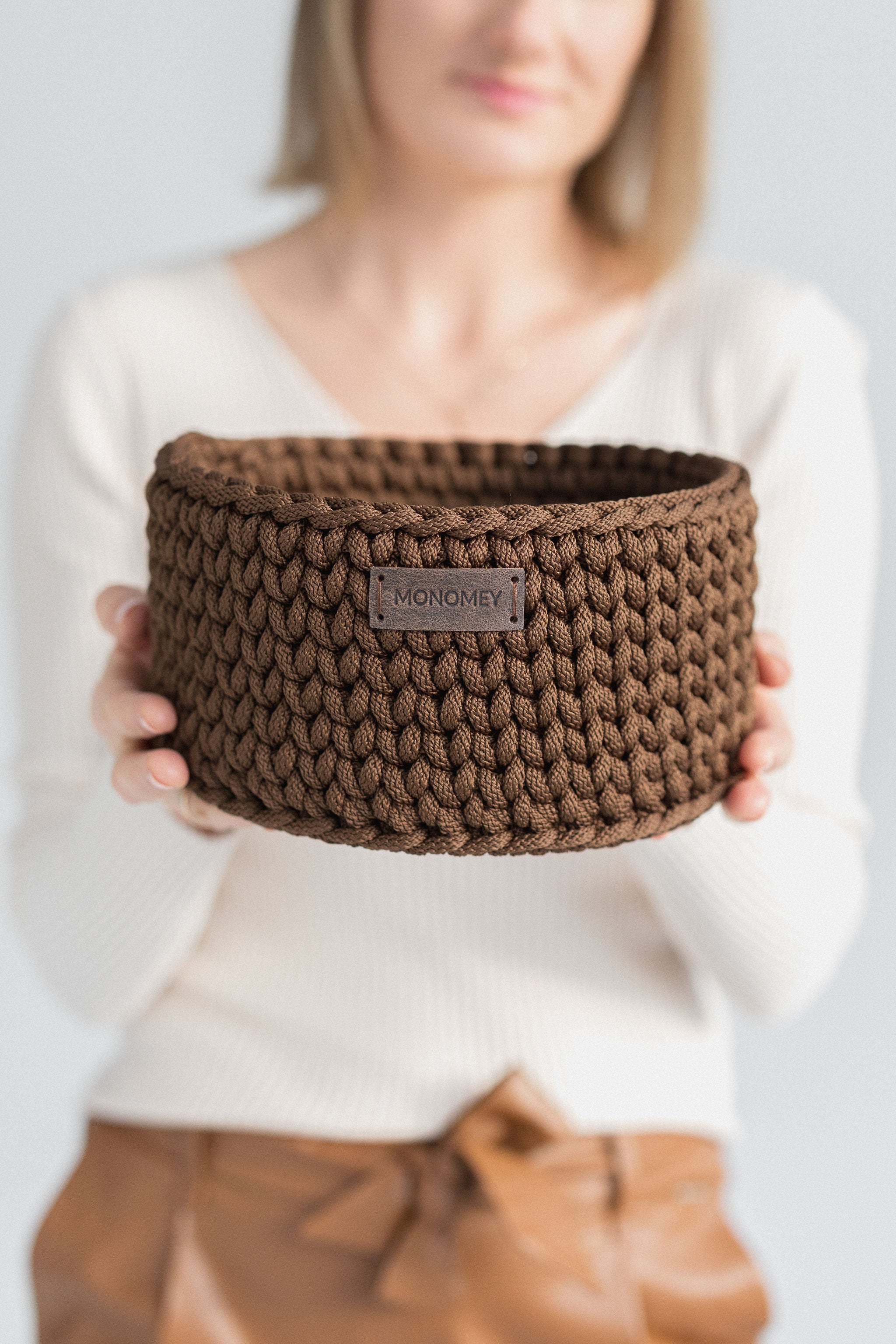 Brown crochet basket with wooden base