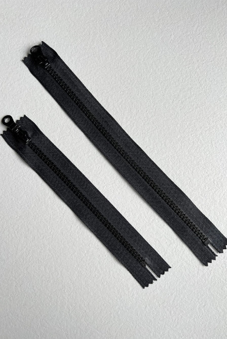 Black plastic zippers