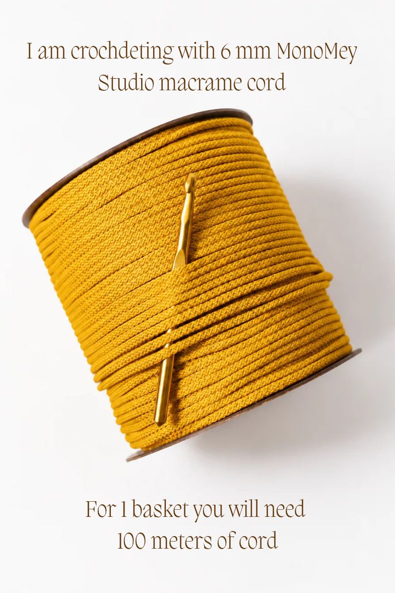 A spool of mustard yellow crocheting cord wrapped diagonally, with a gold crochet hook resting on top. Text on a white background reads: 'I am crocheting with 6 mm MonoMey Studio macrame cord' and 'For 1 basket you will need 100 meters of cord'.