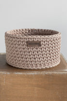 Beige crochet basket with wooden base